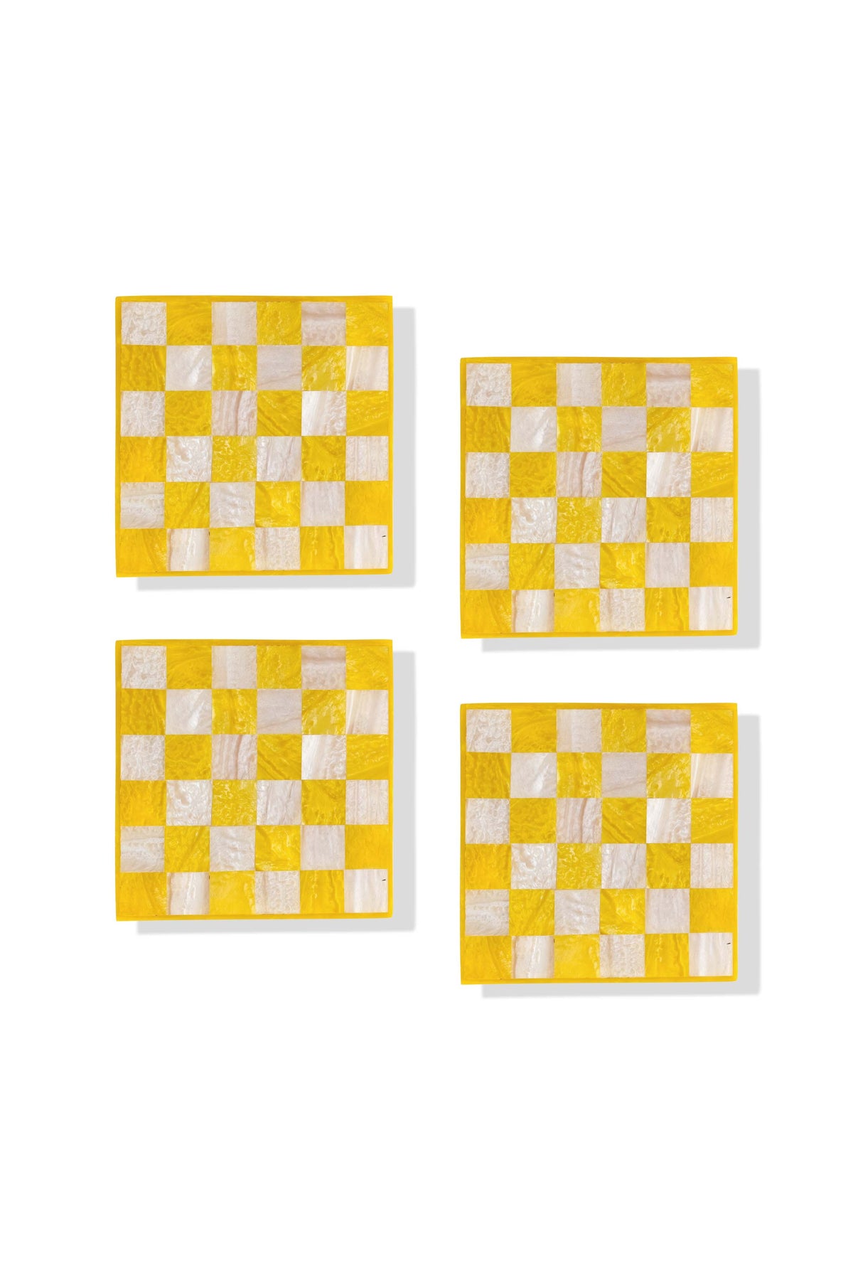 Four square yellow and white checkered coasters arranged in a 2x2 grid on a white background.
