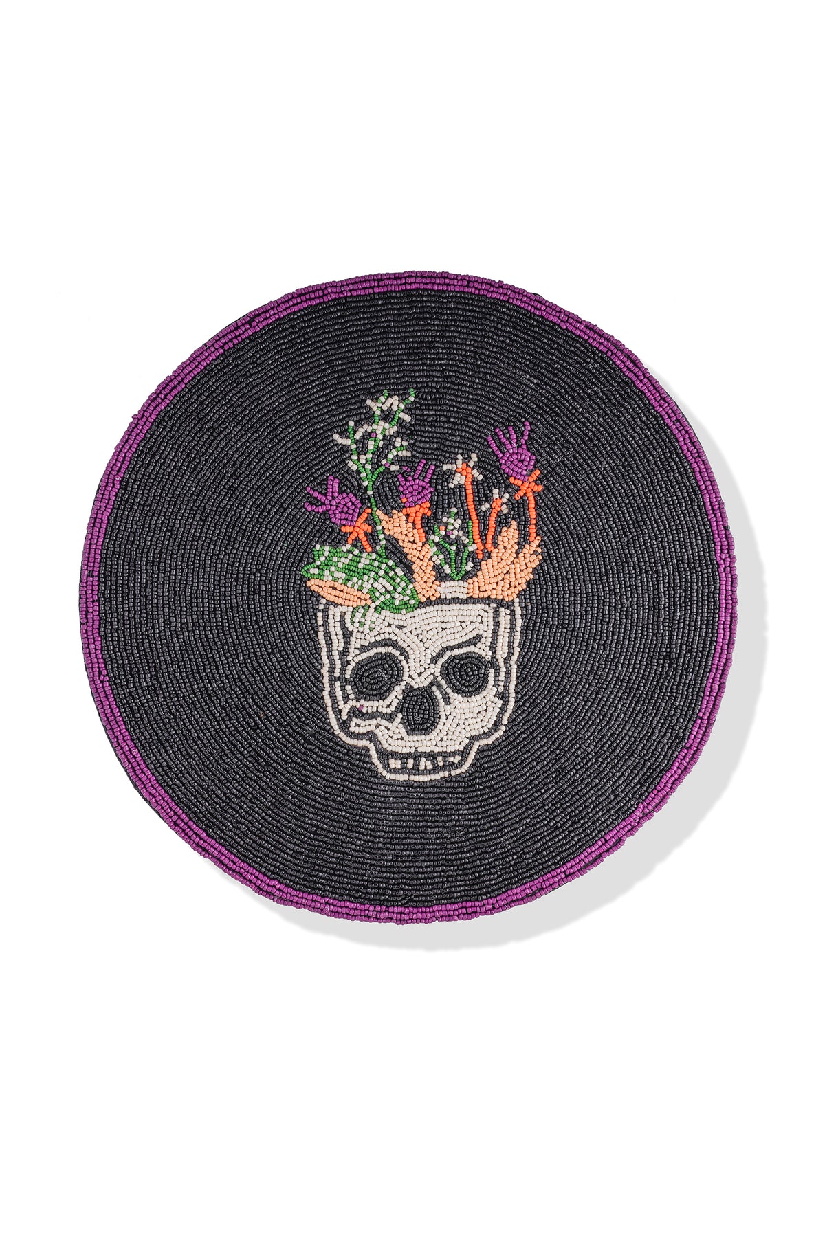 A circular black beaded patch featuring a white skull with a planter of colorful flowers and cacti, and a purple beaded border, shown on a white background.