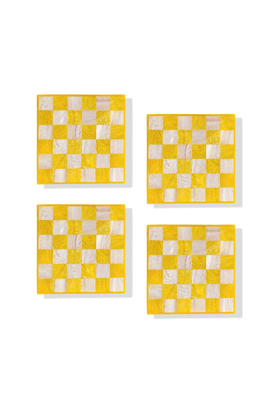 Four square yellow and white checkered coasters arranged in a 2x2 grid on a white background.